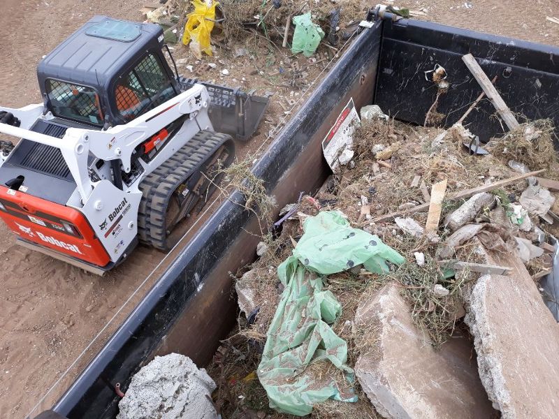 rubbish-in-bin-bobcat-on-side